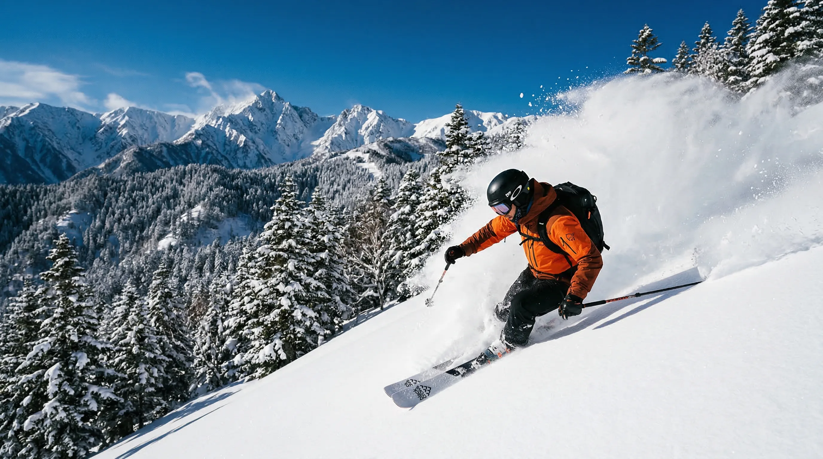 Skier carving through deep powder snow in the Japanese Alps